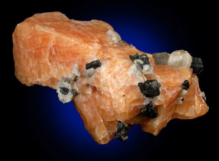 Diopside and Scapolite in orange Calcite from Route 6 road cut, Bear Mountain, Highland Falls, Orange County, New York