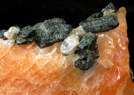 Diopside and Scapolite in orange Calcite from Route 6 road cut, Bear Mountain, Highland Falls, Orange County, New York