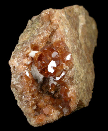 Grossular var. Essonite Garnet from Garnet exposure 175 m. SW of West Redding train station, Fairfield County, Connecticut