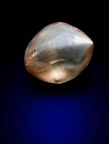 Diamond (0.79 carat orange-brown elongated crystal) from Oranjemund District, southern coastal Namib Desert, Namibia