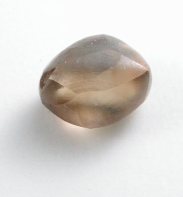 Diamond (0.79 carat orange-brown elongated crystal) from Oranjemund District, southern coastal Namib Desert, Namibia