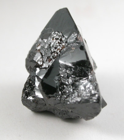 Cassiterite (twinned crystals) from Emmons Quarry, southeastern slope of Uncle Tom Mountain,  Greenwood, Oxford County, Maine