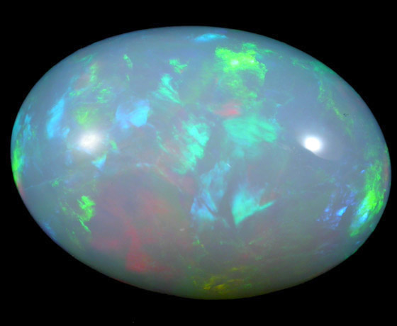 Opal var. Crystal Fire Opal (cabochon and rough) from 570 km north of Addis Ababa, Wello (Wollo), Delanta Plateau, Tigray, Ethiopia