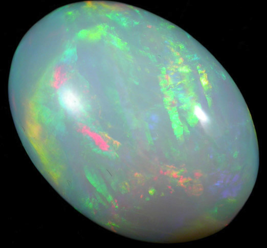 Opal var. Crystal Fire Opal (cabochon and rough) from 570 km north of Addis Ababa, Wello (Wollo), Delanta Plateau, Tigray, Ethiopia