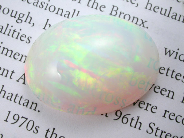 Opal var. Crystal Fire Opal (cabochon and rough) from 570 km north of Addis Ababa, Wello (Wollo), Delanta Plateau, Tigray, Ethiopia