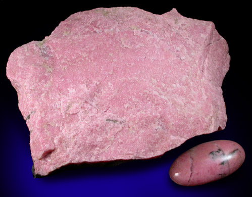 Rhodonite cabochon and lapidary rough from Betts Manganese Mine, Plainfield, Hampshire County, Massachusetts
