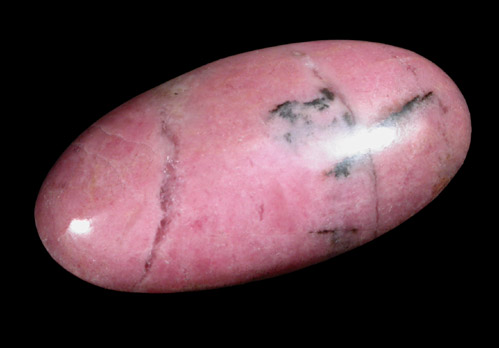 Rhodonite cabochon and lapidary rough from Betts Manganese Mine, Plainfield, Hampshire County, Massachusetts