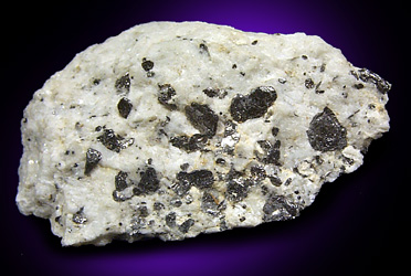 Graphite in marble from Lime Crest Quarry (Limecrest), Sussex Mills, 4.5 km northwest of Sparta, Sussex County, New Jersey