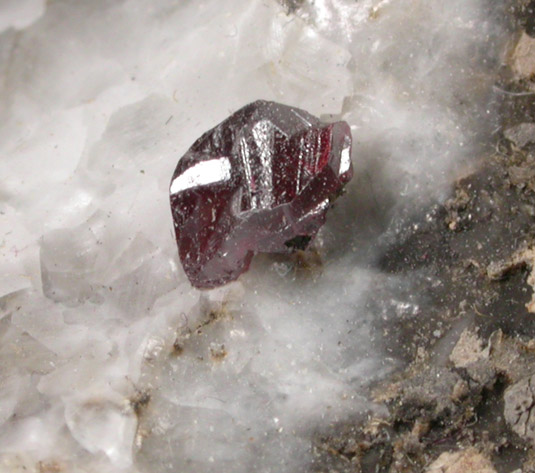 Cinnabar (penetration twin) on Calcite from Red Bird Mine, Antelope Springs District, 24 km east of Lovelock, Pershing County, Nevada