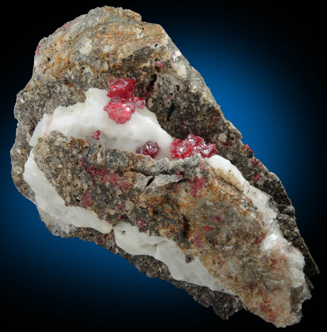 Cinnabar (penetration twins) in Calcite from Red Bird Mine, Antelope Springs District, 24 km east of Lovelock, Pershing County, Nevada