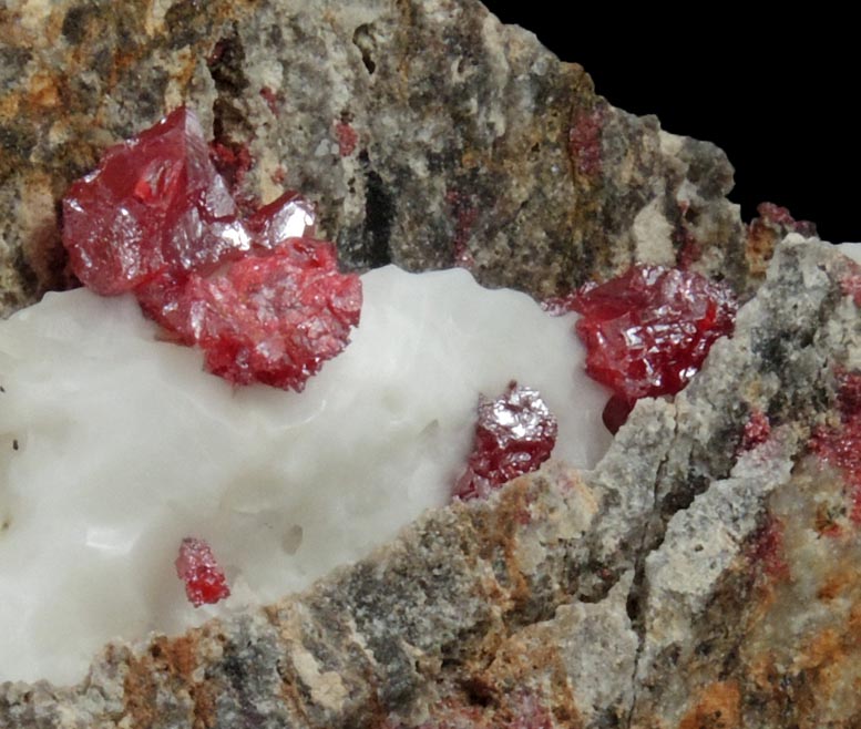 Cinnabar (penetration twins) in Calcite from Red Bird Mine, Antelope Springs District, 24 km east of Lovelock, Pershing County, Nevada