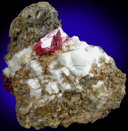 Cinnabar (penetration twin) on Calcite from Red Bird Mine, Antelope Springs District, 24 km east of Lovelock, Pershing County, Nevada