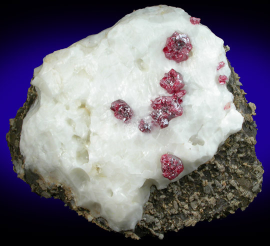 Cinnabar (penetration twins) on Calcite from Red Bird Mine, Antelope Springs District, 24 km east of Lovelock, Pershing County, Nevada