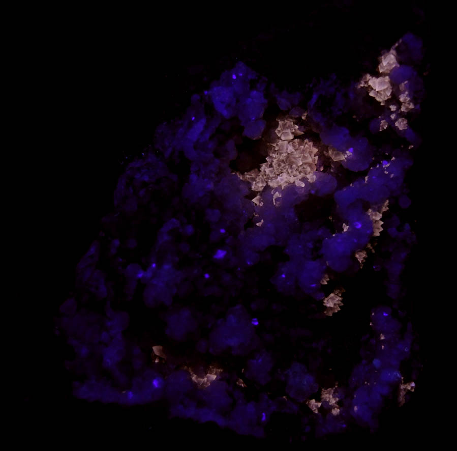 Photo below under shortwave ultraviolet illumination of Apophyllite on Prehnite with Calcite from O and G Industries Southbury Quarry, Southbury, New Haven County, Connecticut Apophyllite on Prehnite with Calcite from O and G Industries Southbury Quarry, Southbury, New Haven County, Connecticut