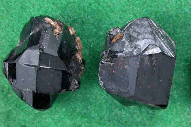 Cassiterite (three mounted crystals) from Elsmore Hill, New South Wales, Australia