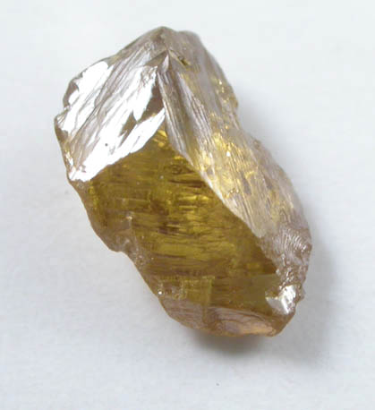 Diamond (0.55 carat fancy-intense yellow-orange asymmetric partial crystal) from Argyle Mine, Kimberley, Western Australia, Australia