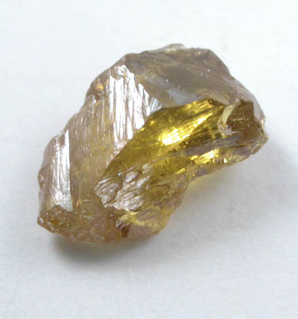 Diamond (0.55 carat fancy-intense yellow-orange asymmetric partial crystal) from Argyle Mine, Kimberley, Western Australia, Australia