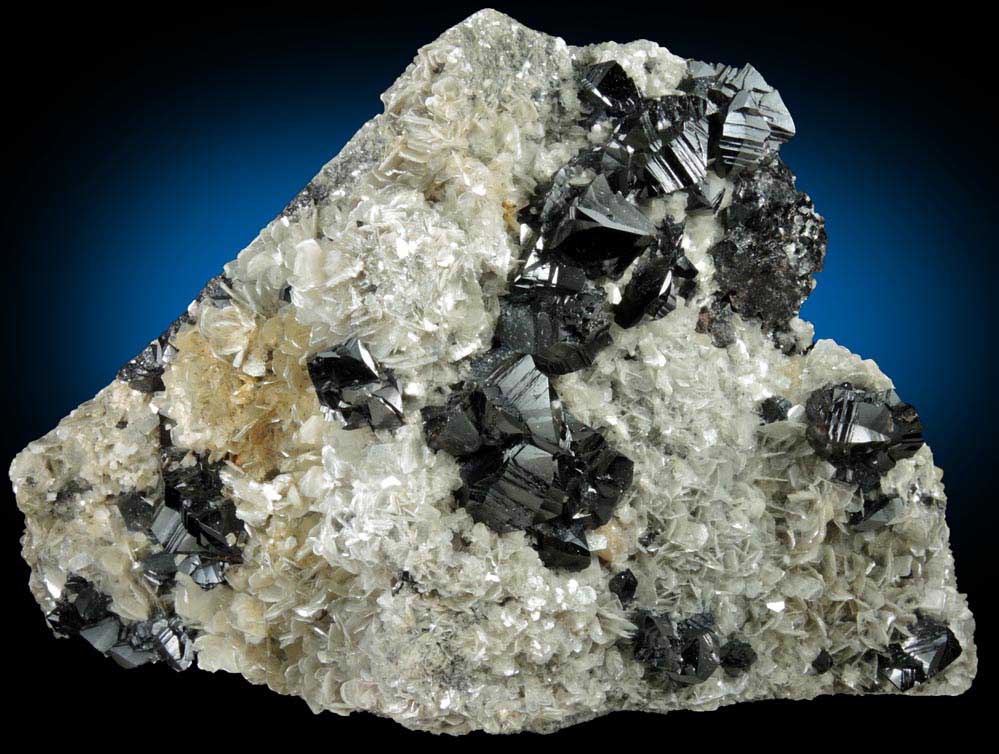 Cassiterite (twinned crystals) on Muscovite from Xuebaoding Mountain near Pingwu, Sichuan Province, China