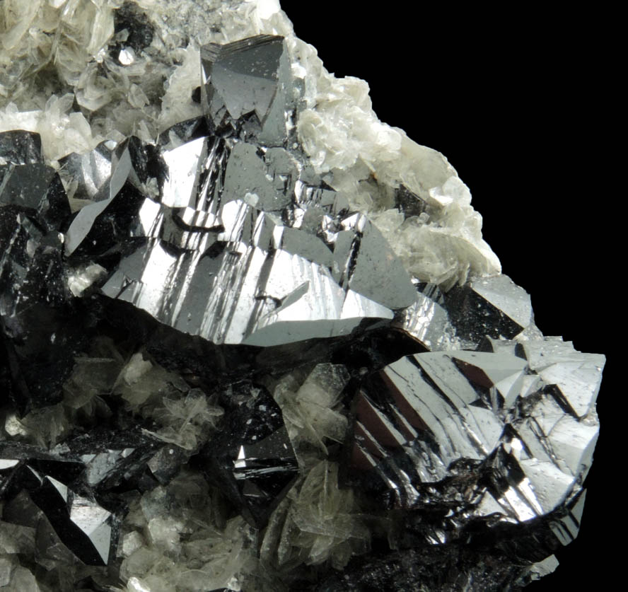 Cassiterite (twinned crystals) on Muscovite from Xuebaoding Mountain near Pingwu, Sichuan Province, China