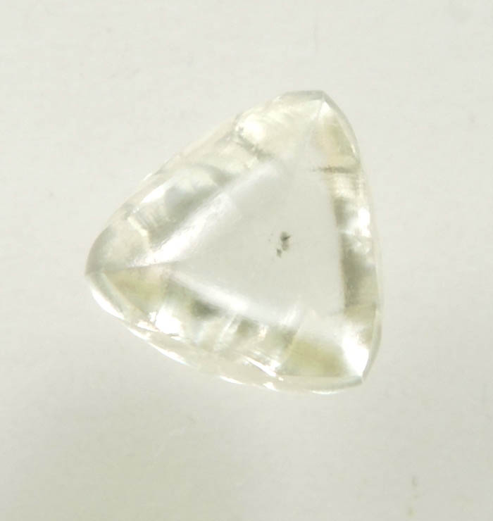 Diamond (0.65 carat cuttable yellow distorted triangular crystal) from Orapa Mine, south of the Makgadikgadi Pans, Botswana