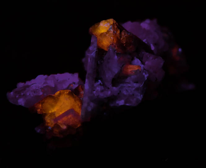 Photo below under shortwave ultraviolet illumination of Fluorapatite with Bertrandite from Lavra da Golconda, near Governador Valadares, Minas Gerais, Brazil Fluorapatite with Bertrandite from Lavra da Golconda, near Governador Valadares, Minas Gerais, Brazil