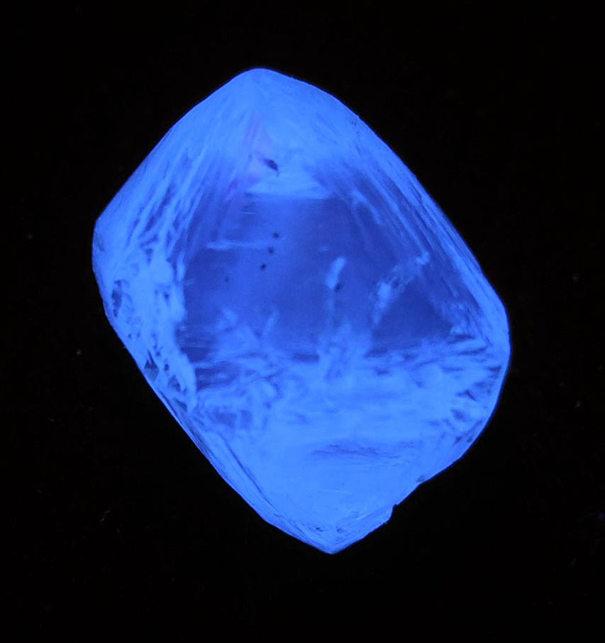 Photo below under shortwave ultraviolet illumination of Diamond (4 carat cuttable pale-yellow octahedral diamond) from Mirny, Sakha Republic, Siberia, Russia Diamond (4 carat cuttable pale-yellow octahedral diamond) from Mirny, Sakha Republic, Siberia, Russia