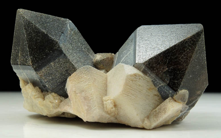 Quartz var. Smoky Quartz (Dauphiné-law twin) on Microcline from Hurricane Mountain, east of Intervale, Carroll County, New Hampshire