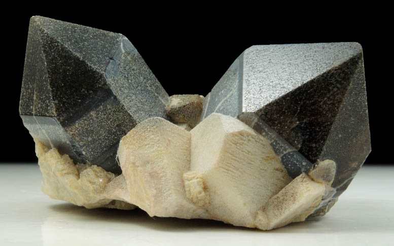 Quartz var. Smoky Quartz (Dauphin-law twin) on Microcline from Hurricane Mountain, east of Intervale, Carroll County, New Hampshire