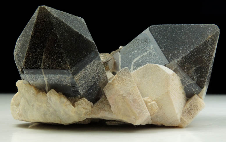 Quartz var. Smoky Quartz (Dauphin-law twin) on Microcline from Hurricane Mountain, east of Intervale, Carroll County, New Hampshire