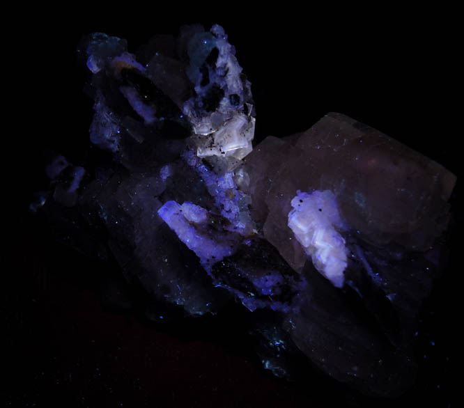 Photo below under longwave ultraviolet illumination of Calcite with Fluorite and Pyrite from Villabona District, Asturias, Spain Calcite with Fluorite and Pyrite from Villabona District, Asturias, Spain