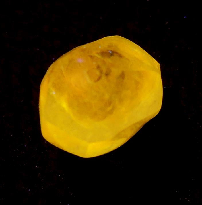 Photo below under longwave ultraviolet illumination of Diamond (1.67 carat fancy-yellow tetrahexahedral rough uncut diamond) from Jwaneng Mine, Naledi River Valley, Botswana Diamond (1.67 carat fancy-yellow tetrahexahedral rough uncut diamond) from Jwaneng Mine, Naledi River Valley, Botswana
