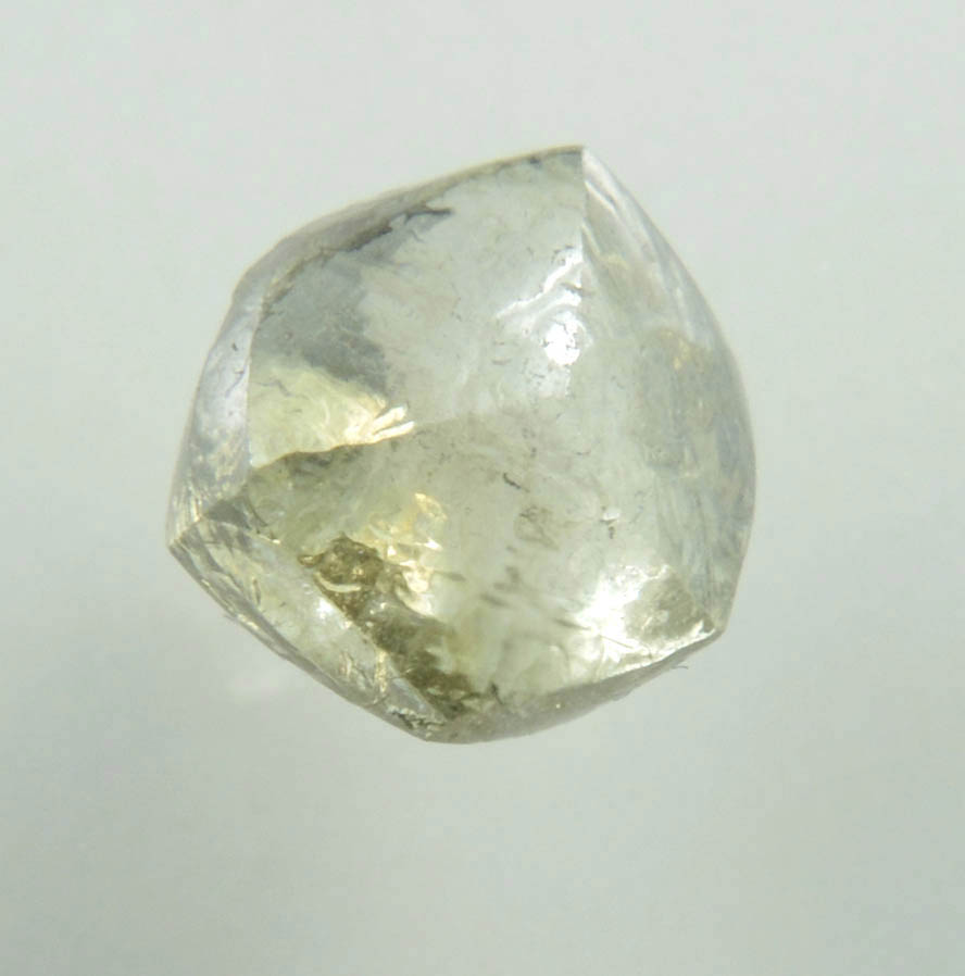 Diamond (1.29 carat fancy yellowish-green flattened dodecahedral uncut diamond) from Oranjemund District, southern coastal Namib Desert, Namibia