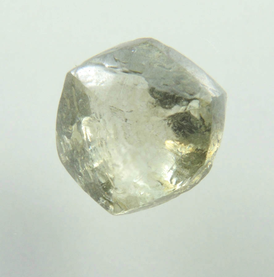 Diamond (1.29 carat fancy yellowish-green flattened dodecahedral uncut diamond) from Oranjemund District, southern coastal Namib Desert, Namibia