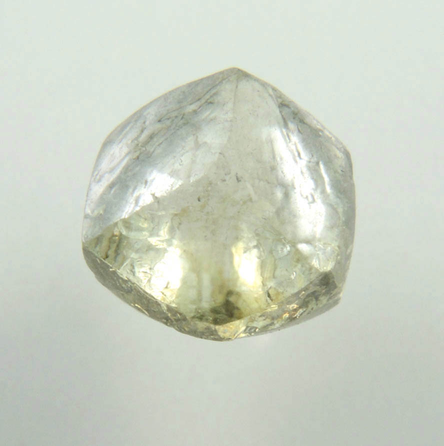 Diamond (1.29 carat fancy yellowish-green flattened dodecahedral uncut diamond) from Oranjemund District, southern coastal Namib Desert, Namibia