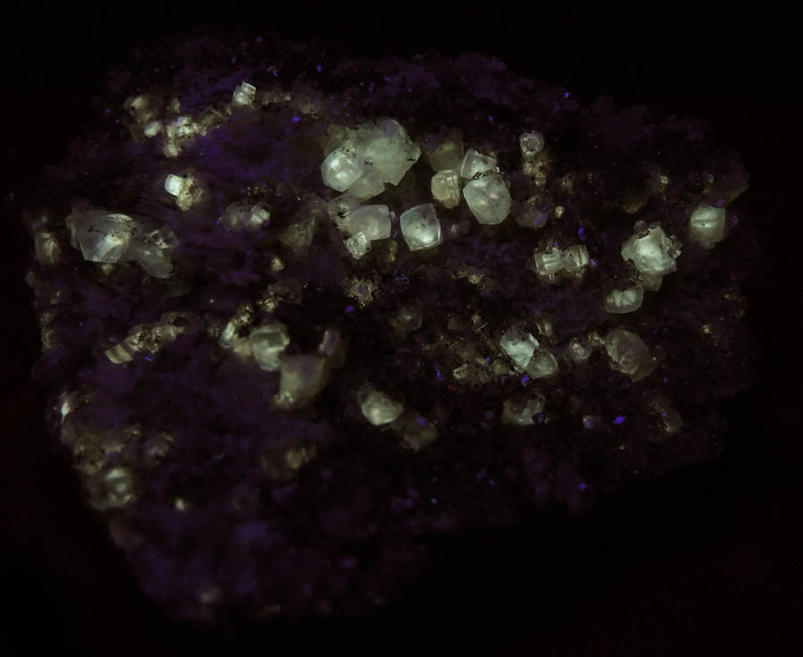 Photo below under shortwave ultraviolet illumination of Apophyllite with Calcite on Datolite from Millington Quarry, Bernards Township, Somerset County, New Jersey Apophyllite with Calcite on Datolite from Millington Quarry, Bernards Township, Somerset County, New Jersey