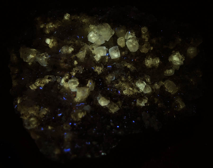 Photo below under longwave ultraviolet illumination of Apophyllite with Calcite on Datolite from Millington Quarry, Bernards Township, Somerset County, New Jersey Apophyllite with Calcite on Datolite from Millington Quarry, Bernards Township, Somerset County, New Jersey