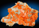 Wulfenite on Calcite from Jianshan Mine, Kuruktag Mountains, 300 km southeast of rmqi, Shanshan County, Xinjiang Uygur Region, China