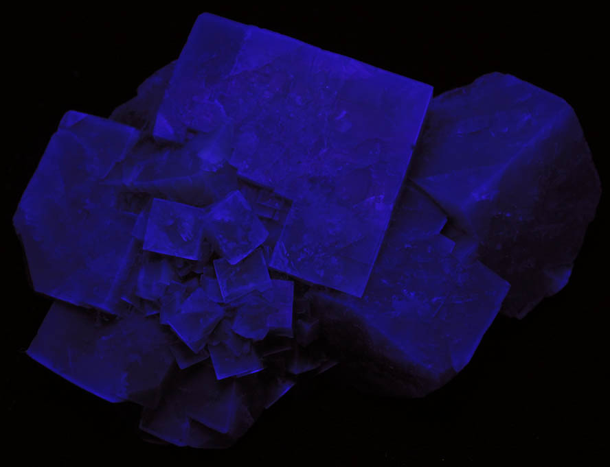 Photo below under shortwave ultraviolet illumination of Fluorite over Siderite from (West Pastures Mine), Weardale District, County Durham, England Fluorite over Siderite from (West Pastures Mine), Weardale District, County Durham, England