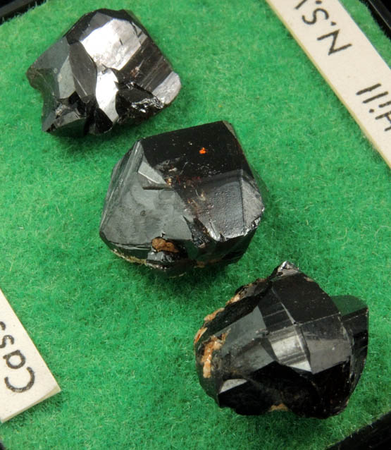 Cassiterite (3 mounted crystals) from Elsmore Hill, New South Wales, Australia