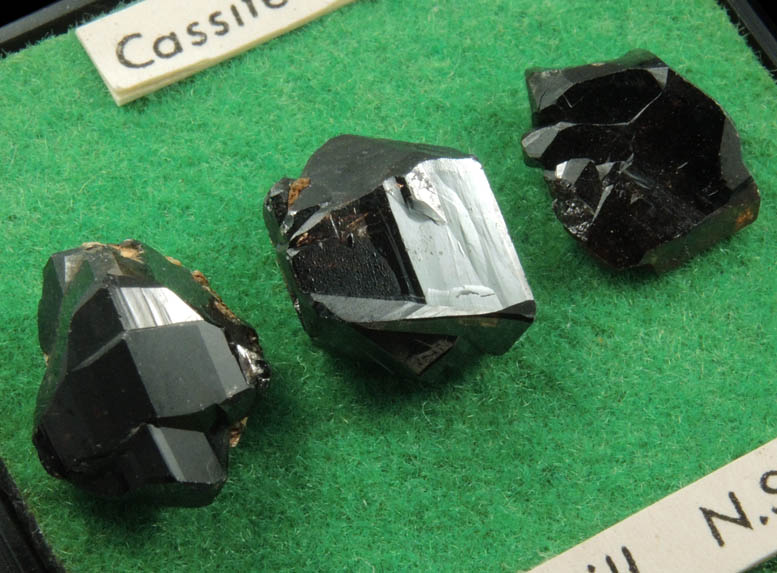 Cassiterite (3 mounted crystals) from Elsmore Hill, New South Wales, Australia