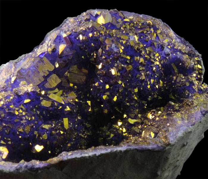 Quartz geode coated with yellow-metallic highlights over purple dye (FAKE) from Man-made