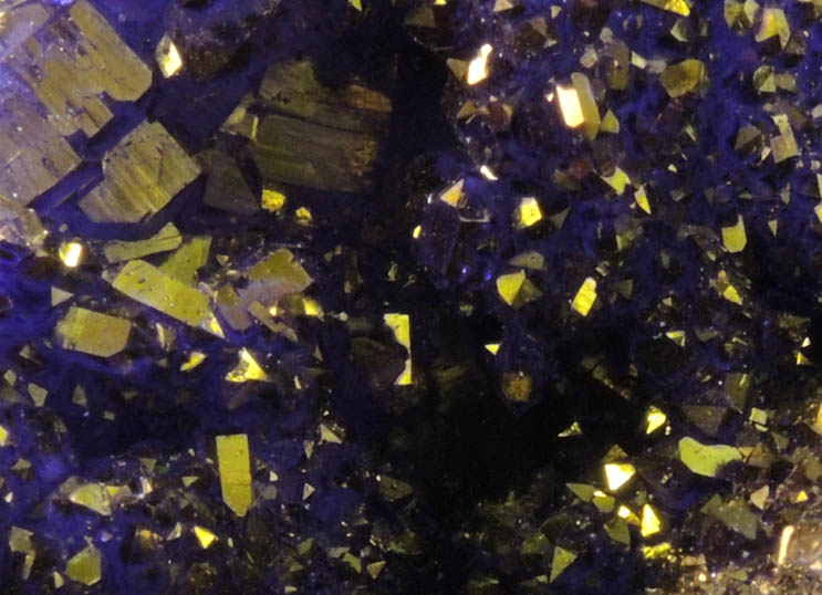 Quartz geode coated with yellow-metallic highlights over purple dye (FAKE) from Man-made