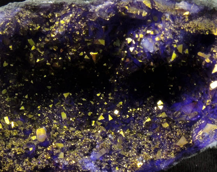 Quartz geode coated with yellow-metallic highlights over purple dye (FAKE) from Man-made