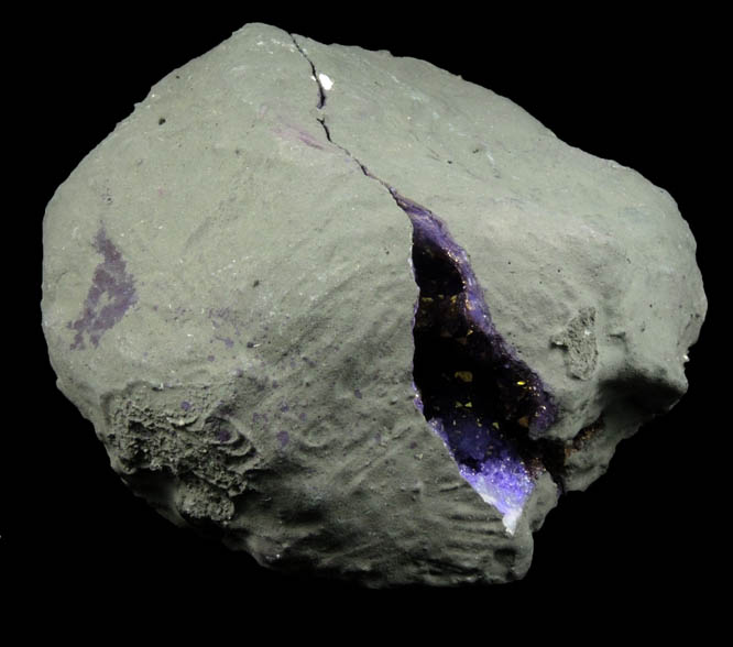 Quartz geode coated with yellow-metallic highlights over purple dye (FAKE) from Man-made