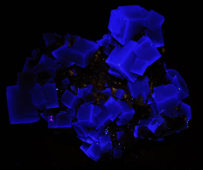 Photo below under longwave ultraviolet illumination of Fluorite with minor Calcite from Huangshaping Mine, Chenzhou, Hunan, China Fluorite with minor Calcite from Huangshaping Mine, Chenzhou, Hunan, China