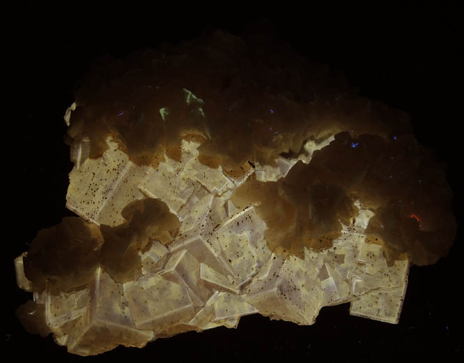 Photo below under longwave ultraviolet illumination of Dolomite over Fluorite from Moscona Mine, Villabona District, Asturias, Spain Dolomite over Fluorite from Moscona Mine, Villabona District, Asturias, Spain