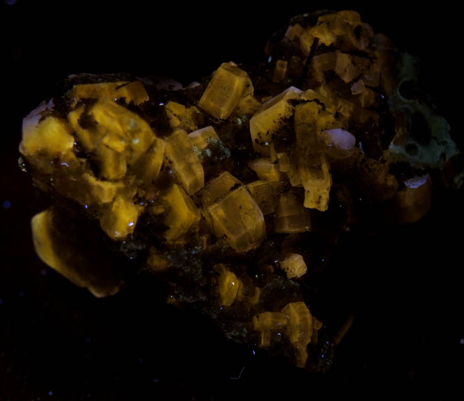 Photo below under longwave ultraviolet illumination of Fluorapatite with Muscovite from Panasqueira Mine, Barroca Grande, 21 km. west of Fundao, Castelo Branco, Portugal Fluorapatite with Muscovite from Panasqueira Mine, Barroca Grande, 21 km. west of Fundao, Castelo Branco, Portugal