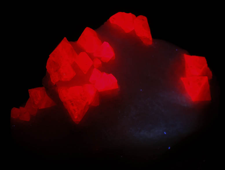 Photo below under longwave ultraviolet illumination of Spinel in marble from Sungate Mine, An Phu, Luc Yen, Yen Bai Province, Vietnam Spinel in marble from Sungate Mine, An Phu, Luc Yen, Yen Bai Province, Vietnam