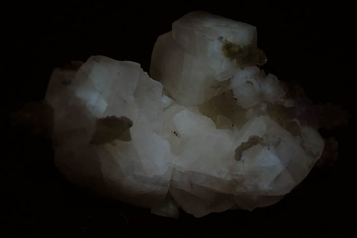 Photo below under longwave ultraviolet illumination of Calcite from Millington Quarry, Bernards Township, Somerset County, New Jersey Calcite from Millington Quarry, Bernards Township, Somerset County, New Jersey