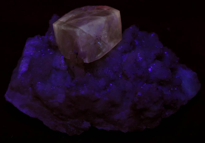 Photo below under shortwave ultraviolet illumination of Calcite on Datolite with Pyrite from Millington Quarry, Bernards Township, Somerset County, New Jersey Calcite on Datolite with Pyrite from Millington Quarry, Bernards Township, Somerset County, New Jersey